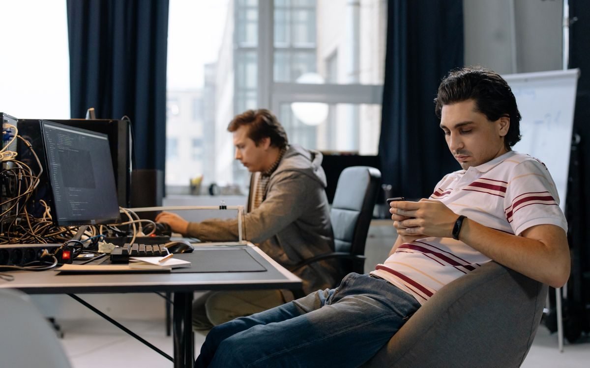 Team of developers working together at desks in an open-plan office